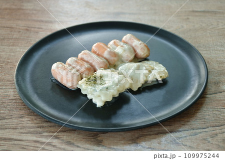 steamed Ravioli with pork sausage dressing carbonara white sauce topping chop seaweed on plate steamed Ravioli with pork sausage dressing carbonara white sauce topping chop seaweed on plate 109975244