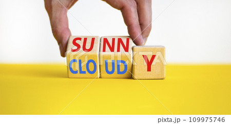 Sunny or cloudy symbol. Concept word Sunny or Cloudy on wooden cubes. Beautiful yellow table white background. Businessman hand. Business lifestyle and sunny or cloudy concept. Copy space. 109975746