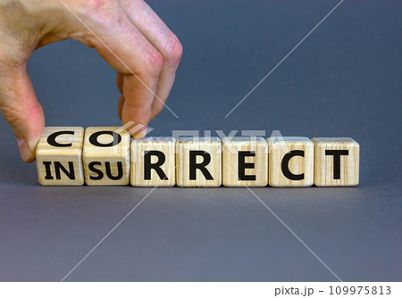 Correct vs insurrect symbol. Businessman hand turns wooden cubes and changes the word 'insurrect' to 'correct'. Beautiful grey background, copy space. Business, correct vs insurrect concept. 109975813