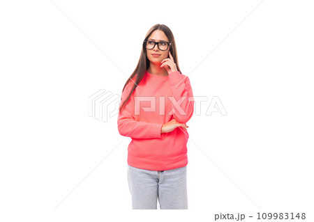 beautiful well-groomed young brunette european woman in glasses dressed in a pink sweatshirt on an 109983148