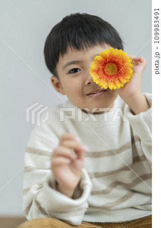 一輪の花を持った男の子　カメラ目線　ポートレート 109983491
