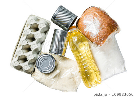 Donation food goods, quarantine help concept. Oil, canned food, pasta, bread, sugar, egg. Isolated on white background, top view. Donation food goods, quarantine help concept. Oil, canned food, pasta, bread, sugar, egg. Isolated on white background, top view. 109983656