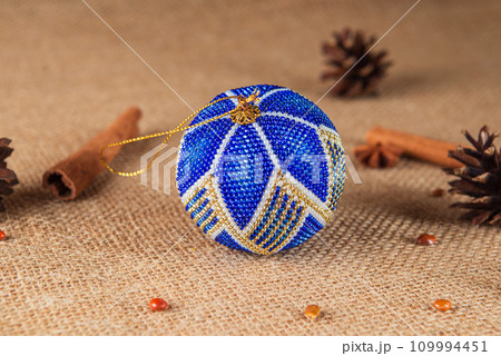 Exquisite handmade Christmas bubble toy from beads, also known as a Christmas globe or Christmas bulb, is a part of holiday decor Exquisite handmade Christmas bubble toy from beads, also known as a Christmas globe or Christmas bulb, is a part of holiday decor 109994451
