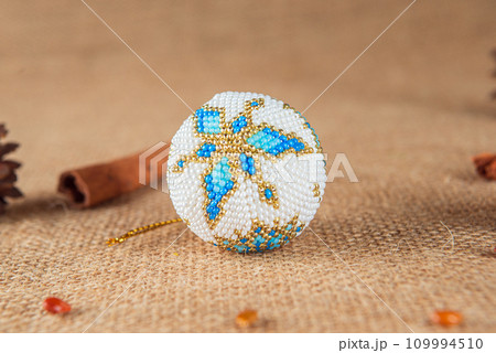 Exquisite handmade Christmas bubble toy from beads, also known as a Christmas globe or Christmas bulb, is a part of holiday decor Exquisite handmade Christmas bubble toy from beads, also known as a Christmas globe or Christmas bulb, is a part of holiday decor 109994510