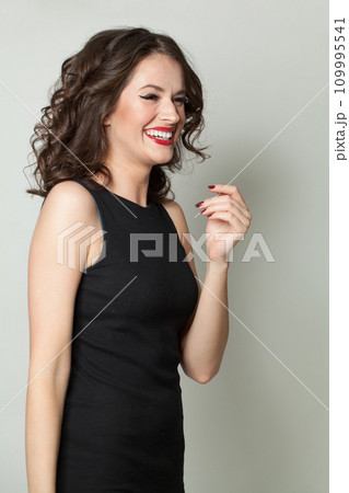 Woman laughing. Portrait of beautiful lady with makeup and wavy hair posing on white background Woman laughing. Portrait of beautiful lady with makeup and wavy hair posing on white background 109995541