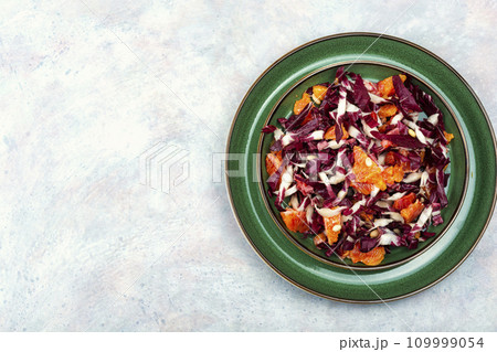 Salad with orange and red organic radicchio. Salad with orange and red organic radicchio. 109999054
