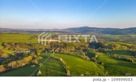 Green rural landscape around Liberec with Jested mountain ridge on background. Sunny summer evening, Czechia 109999083