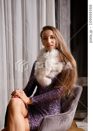 Elegant woman in sequin dress and fur stole Elegant woman in sequin dress and fur stole 109999366