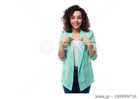 young slim caucasian female model with curly black hair points with index finger 109999730