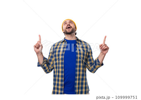 young caucasian brunette handsome man with a beard and mustache points his hand to the side on a 109999751