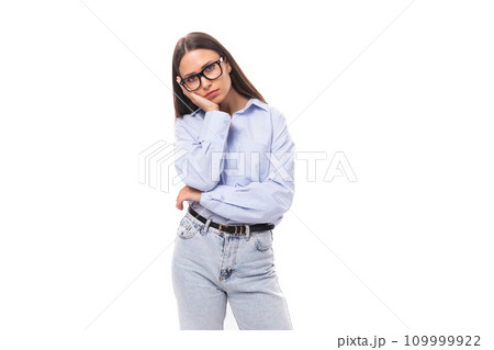 young caucasian model woman with dark straight hair dressed in a blue blouse looks upset at the 109999922
