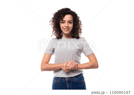 charming caucasian young brunette woman with curly hair dressed in a gray basic t-shirt 110000187