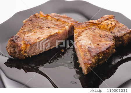 Grilled pork steak in frying pan on black background with copy space. Top view, flat lay food Grilled pork steak in frying pan on black background with copy space. Top view, flat lay food 110001031