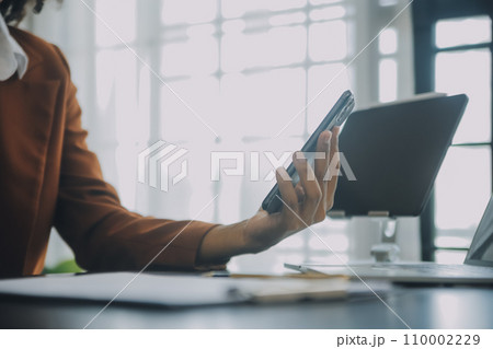 Creative Asian young woman working on laptop in her studio 110002229