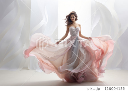 Woman in a flowing pastel dress, standing against a clean, soft-hued backdrop, emphasizing the airy and graceful design of the garment 110004126