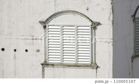Fake window of white terraced residential buildings with where the upper floor is used as a place for cultivating swallow's nests (Collocalia vestita). Bird nest soup food farming. Fake window of white terraced residential buildings with where the upper floor is used as a place for cultivating swallow's nests (Collocalia vestita). Bird nest soup food farming. 110005107