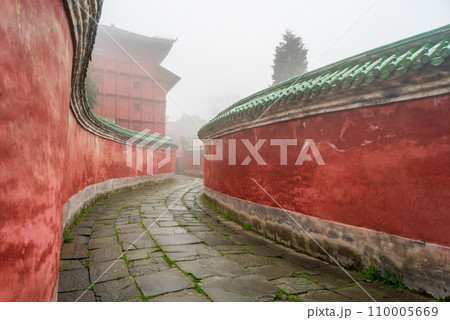 The mysterious ancient building complex of Wudang Mountain in the fog. The mysterious ancient building complex of Wudang Mountain in the fog. 110005669
