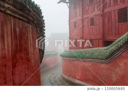 The mysterious ancient building complex of Wudang Mountain in the fog. The mysterious ancient building complex of Wudang Mountain in the fog. 110005680