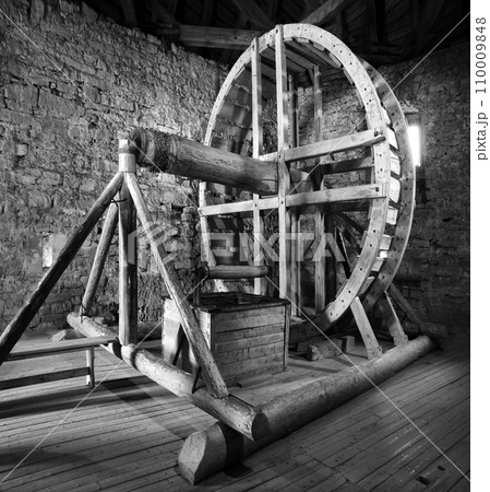 Big wooden millstone wheel in the castle Big wooden millstone wheel in the castle 110009848