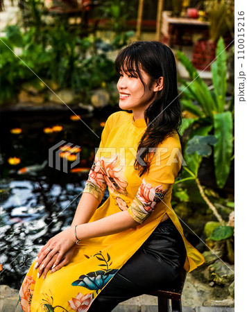 Beautiful Vietnamese woman in traditional vietnamese dress in Tet Lunar New Year Beautiful Vietnamese woman in traditional vietnamese dress in Tet Lunar New Year 110015216