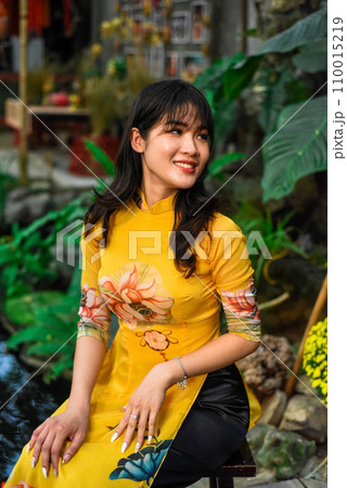 Beautiful Vietnamese woman in traditional vietnamese dress in Tet Lunar New Year Beautiful Vietnamese woman in traditional vietnamese dress in Tet Lunar New Year 110015219