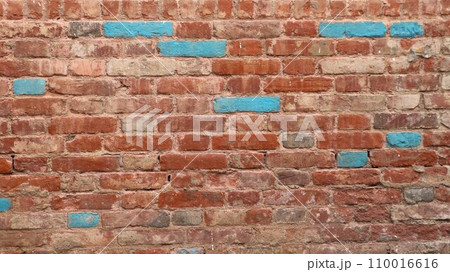 old red brick wall with splashes of blue blocks as a background texture for design, textured brickwork backdrop with empty copy space, graphic resource of the relief surface 110016616