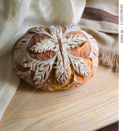 Tasty soft bread on the board 110019640