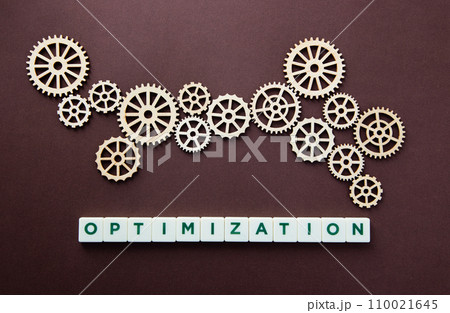 Wooden gear with the word Optimization. Technology concept and optimization. Wooden gear with the word Optimization. Technology concept and optimization. 110021645