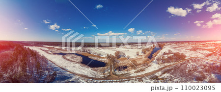 View from above of the countryside and brook on a winter sunny day. Snowy nature landscape with blue sky. Panorama from 21 images View from above of the countryside and brook on a winter sunny day. Snowy nature landscape with blue sky. Panorama from 21 images 110023095