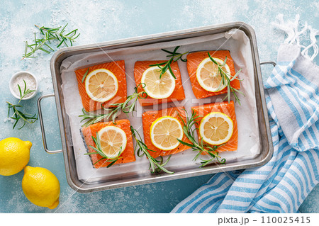 Salmon. Fresh raw salmon fish fillet with cooking ingredients, rosemary and lemon, top view Salmon. Fresh raw salmon fish fillet with cooking ingredients, rosemary and lemon, top view 110025415