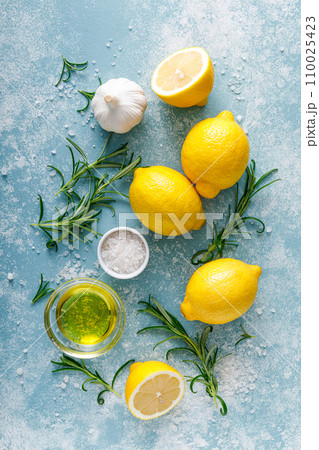 Lemon, rosemary, garlic, salt and olive oil. Ingredients for mediterranean cuisine cooking. Top view 110025423