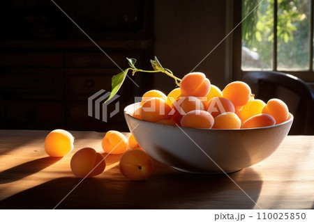 Ripe apricots in bowl on rustic table and window background. Ripe apricots in bowl on rustic table and window background. 110025850