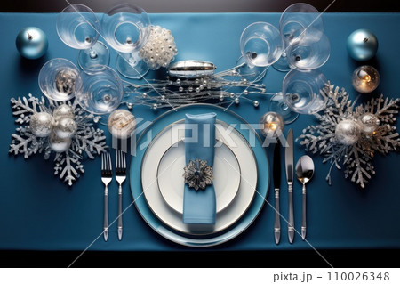 Christmas table setting with dishware, silverware and decorations on festive table. Top view. 110026348