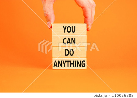 You can do anything symbol. Concept word You can do anything on wooden blocks. Businessman hand. Beautiful orange table orange background. Business and you can do anything concept. Copy space. 110026888