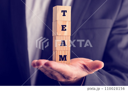 Business man holding wooden cubes reading - Team Business man holding wooden cubes reading - Team 110028156