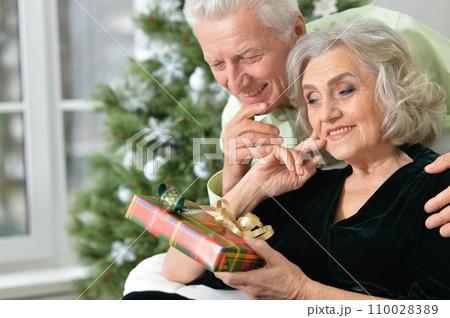 Happy elderly couple celebrating new year at home Happy elderly couple celebrating new year at home 110028389