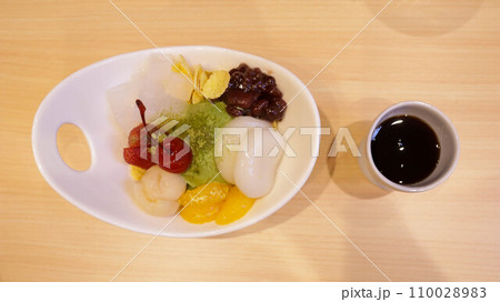 Shiratama Anmitsu is a classic Japanese sweet dumplings served with matcha ice cream, assorted fruits, ogura paste and topped with special brown sugar sauce. 110028983