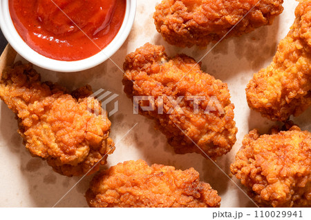 Delicious crispy breaded chicken breast strips on the table. View from above Delicious crispy breaded chicken breast strips on the table. View from above 110029941