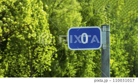 road sign pointer with zero mark on green foliage background road sign pointer with zero mark on green foliage background 110031017