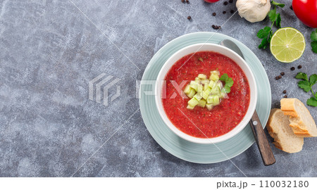 Soup Gazpacho garnished with cucumber and cilantro, in bowl, horizontal top view, copy space 110032180