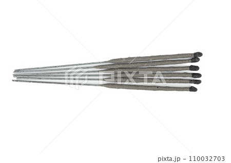 Top view of unlit sparklers on a white background. 110032703