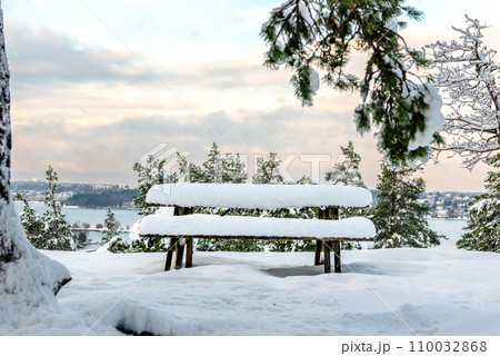 Sweden. Snow in winter park, garden benches under snow Sweden. Snow in winter park, garden benches under snow 110032868
