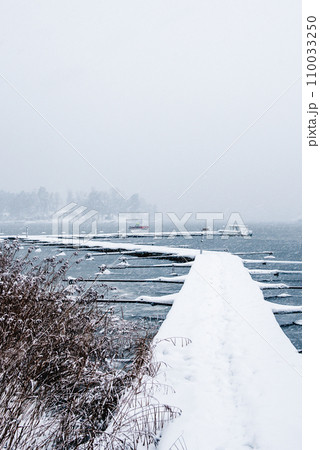 Landscape. Boat pier in winter. A wonderful winter view of the frozen lake. Landscape. Boat pier in winter. A wonderful winter view of the frozen lake. 110033250