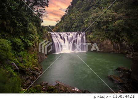 Large waterfall at sunset Large waterfall at sunset 110034421