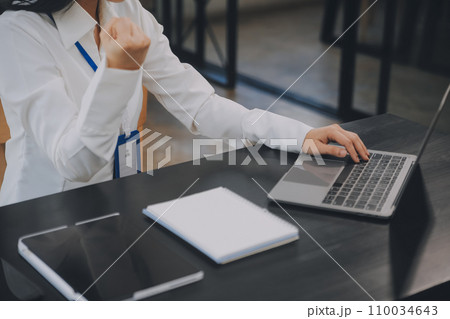 Entrepreneur Asian businessman and businesswoman discussing new business project in tablet in modern Meeting In Modern Office, Asian business casual concept. 110034643