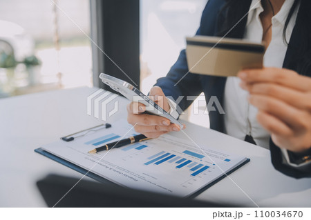 Women holding credit card and using smartphones at home.Online shopping, internet banking, store online, payment, spending money, e-commerce payment at the store, credit card, concept Women holding credit card and using smartphones at home.Online shopping, internet banking, store online, payment, spending money, e-commerce payment at the store, credit card, concept 110034670