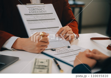 Lawyer, legal advisor, businessman brainstorming information on agreement details Business contracts in legal processing books for accuracy in contract documents. joint financial investment. 110035810