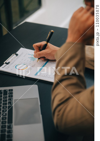 Entrepreneur Asian businessman and businesswoman discussing new business project in tablet in modern Meeting In Modern Office, Asian business casual concept. 110035878