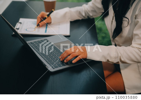 Entrepreneur Asian businessman and businesswoman discussing new business project in tablet in modern Meeting In Modern Office, Asian business casual concept. 110035880