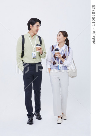 man and woman smiling and talking with a coffee cup 110038729